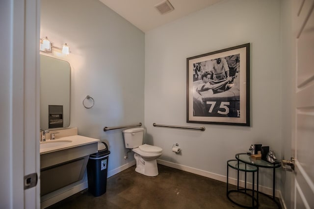 bathroom with toilet, vanity, baseboards, visible vents, and concrete flooring