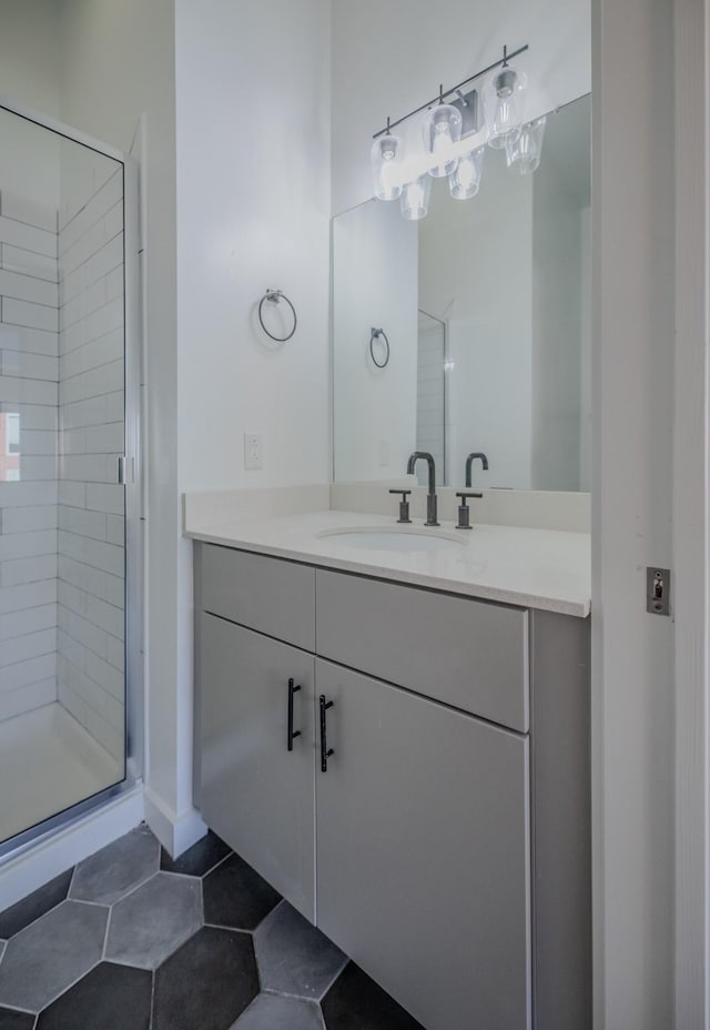 full bath with tile patterned floors, vanity, and a shower stall