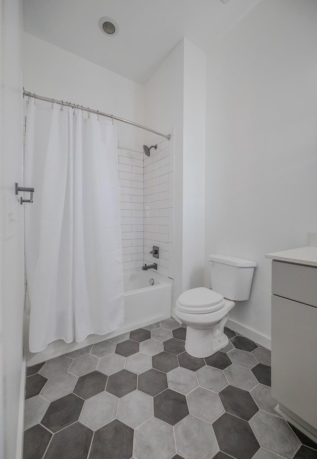 full bathroom with toilet, vanity, shower / bath combo, tile patterned flooring, and baseboards