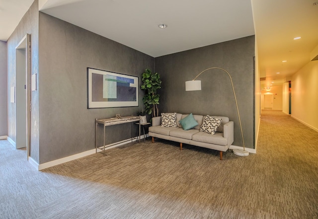 carpeted living area featuring baseboards and recessed lighting