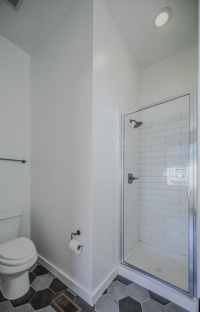 bathroom featuring a shower stall, tile patterned floors, visible vents, and toilet