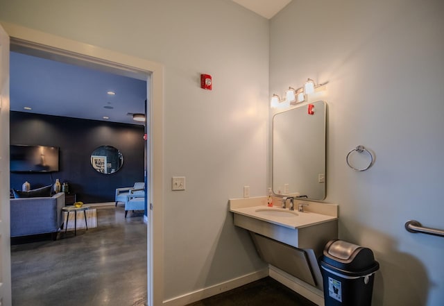 bathroom with a sink and baseboards