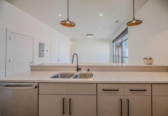 kitchen featuring light countertops, stainless steel dishwasher, a sink, pendant lighting, and electric panel