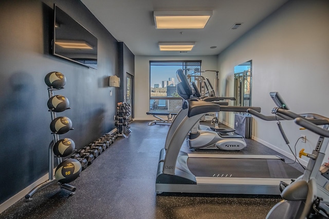 gym featuring baseboards and visible vents