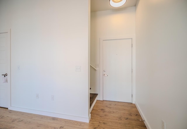 interior space featuring baseboards and light wood-style flooring