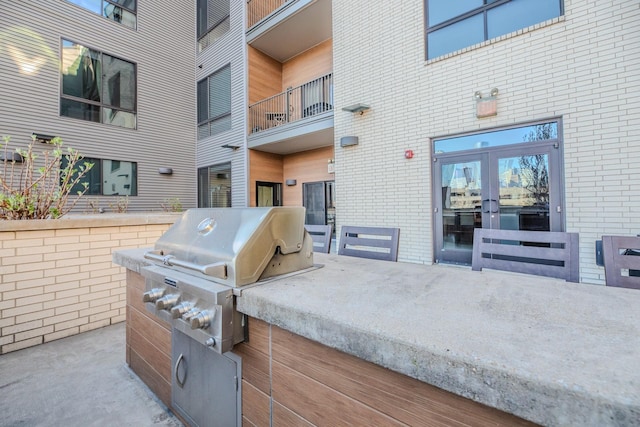view of patio with french doors, grilling area, and area for grilling