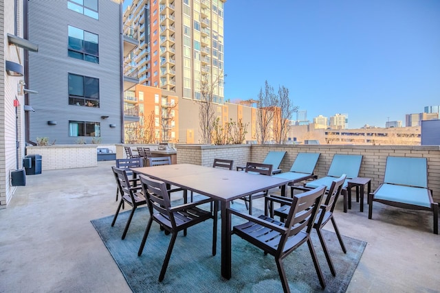 view of patio with a view of city and outdoor dining space