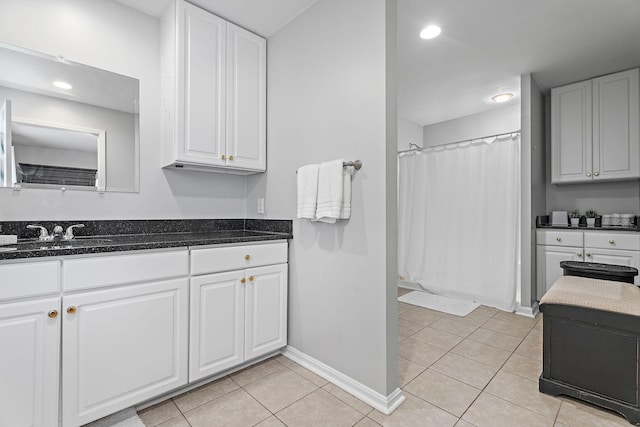 bathroom with tile patterned floors, a shower with shower curtain, and vanity