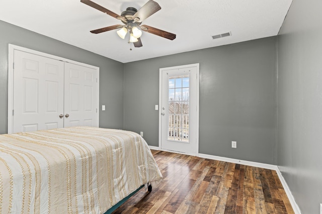 bedroom featuring dark hardwood / wood-style flooring, access to outside, a closet, and ceiling fan