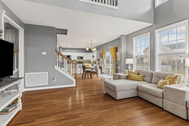 living room featuring a notable chandelier and wood-type flooring