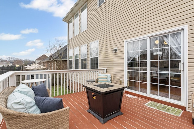 wooden terrace featuring an outdoor fire pit