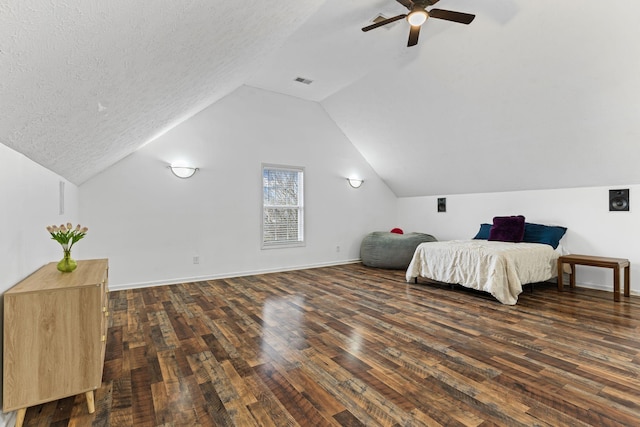 bedroom with lofted ceiling, ceiling fan, dark wood-type flooring, and a textured ceiling