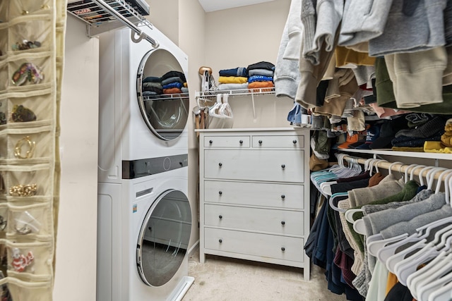 laundry area featuring stacked washing maching and dryer