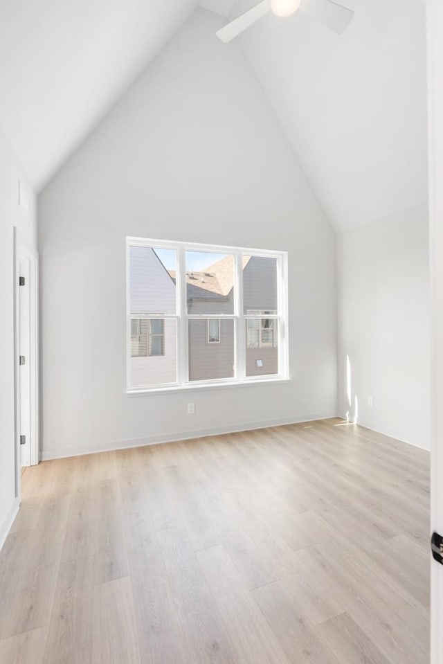 additional living space with light wood-type flooring, high vaulted ceiling, and ceiling fan