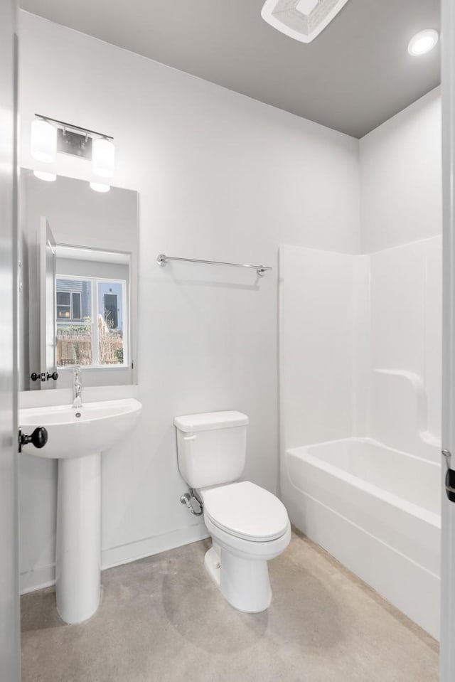 bathroom featuring concrete flooring, toilet, and washtub / shower combination