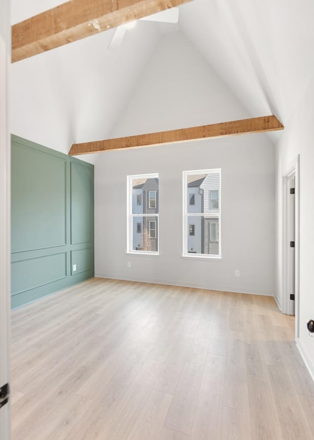 interior space featuring light hardwood / wood-style floors and high vaulted ceiling