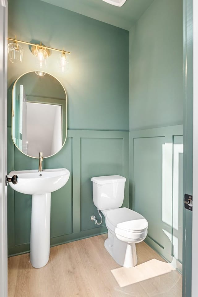 bathroom featuring toilet and hardwood / wood-style floors