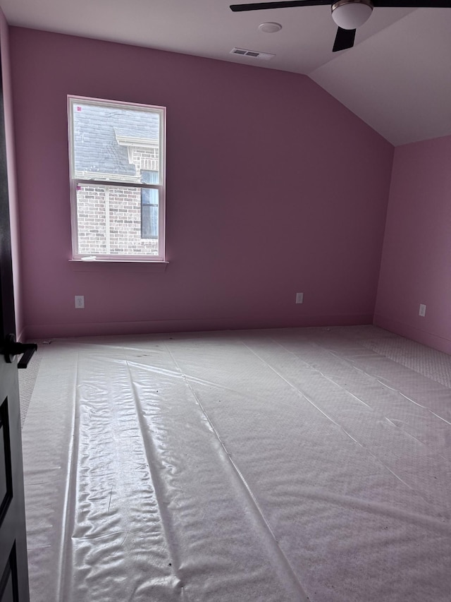 bonus room with vaulted ceiling, light colored carpet, and ceiling fan