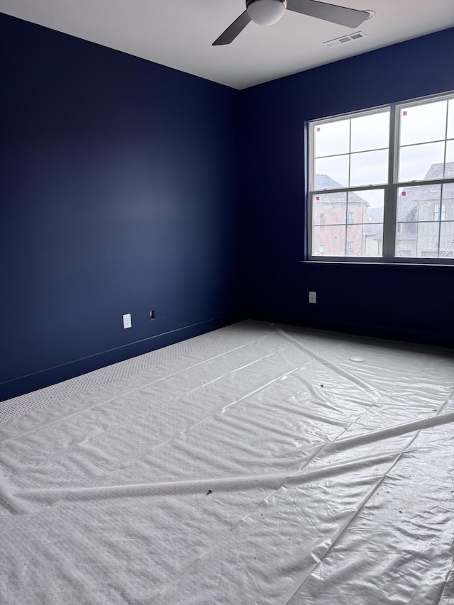 unfurnished room with ceiling fan