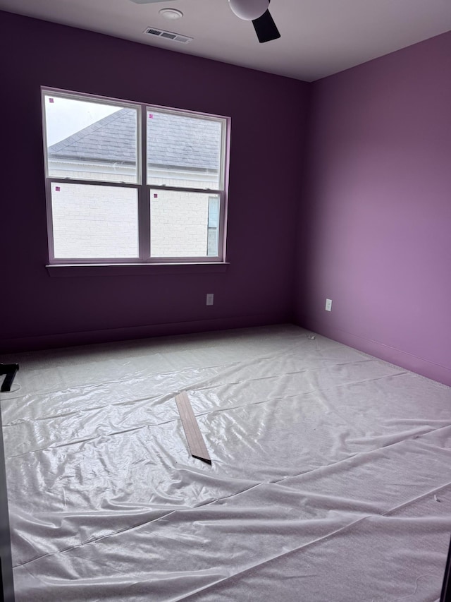 unfurnished room with ceiling fan, carpet floors, and a healthy amount of sunlight