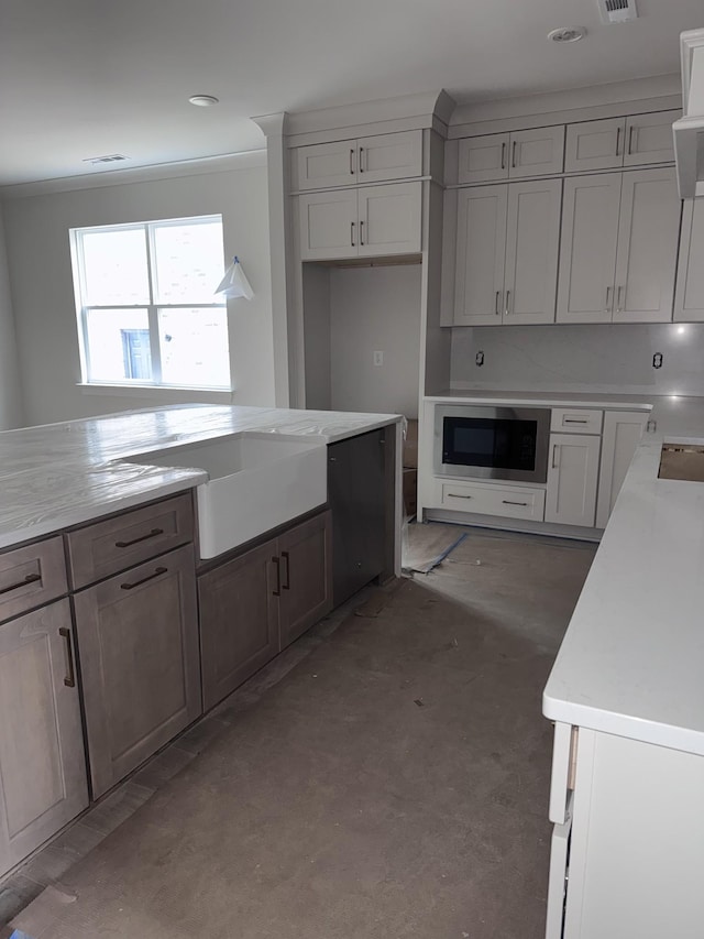 kitchen featuring built in microwave, white cabinetry, sink, concrete floors, and crown molding