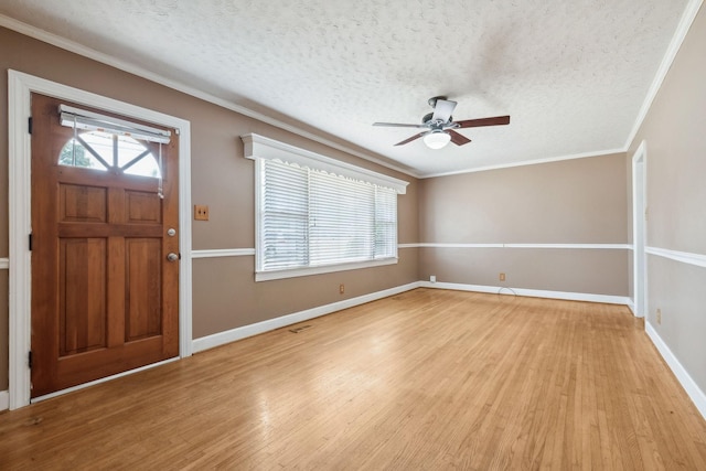 entryway with crown molding, light hardwood / wood-style floors, and a textured ceiling