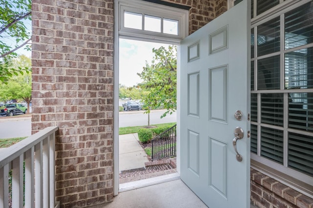 entryway with brick wall