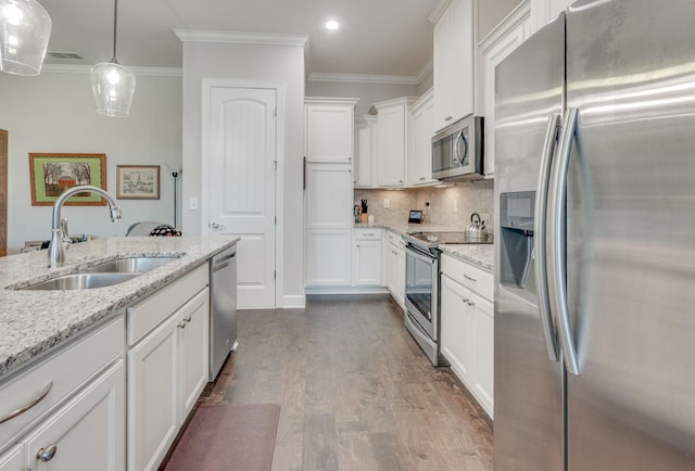 kitchen featuring light stone counters, appliances with stainless steel finishes, sink, and white cabinets