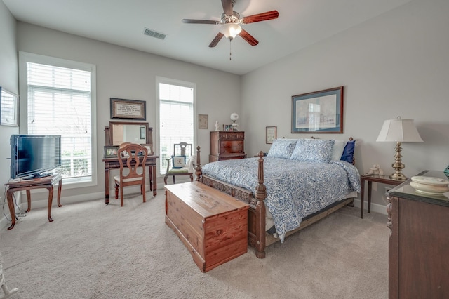 carpeted bedroom with multiple windows and ceiling fan