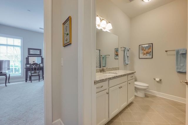 bathroom with tile patterned floors, vanity, and toilet