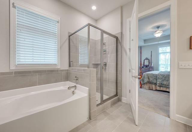 bathroom with ceiling fan, shower with separate bathtub, and tile patterned flooring