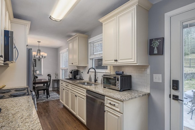 kitchen featuring sink, hanging light fixtures, stainless steel appliances, light stone countertops, and dark hardwood / wood-style flooring