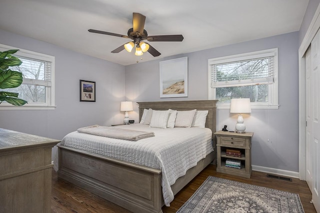 bedroom with ceiling fan, dark hardwood / wood-style floors, and a closet