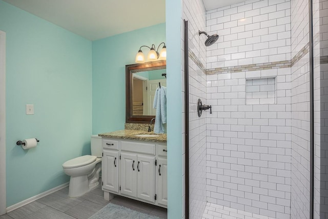 bathroom featuring vanity, toilet, and a shower with shower door