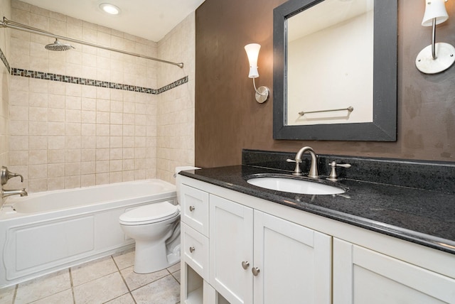 full bathroom with vanity, tiled shower / bath, tile patterned floors, and toilet