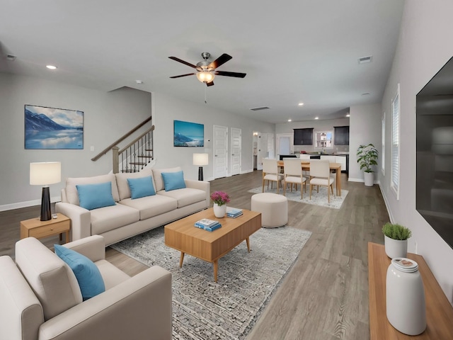 living room featuring ceiling fan and hardwood / wood-style floors