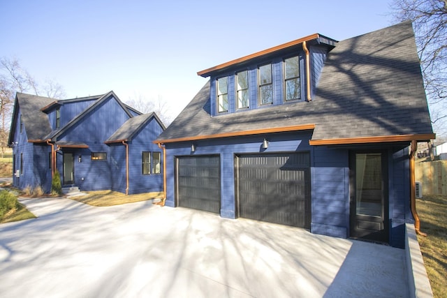 view of front of house with a garage and concrete driveway