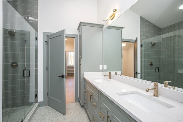 bathroom with lofted ceiling, vanity, and a shower with shower door