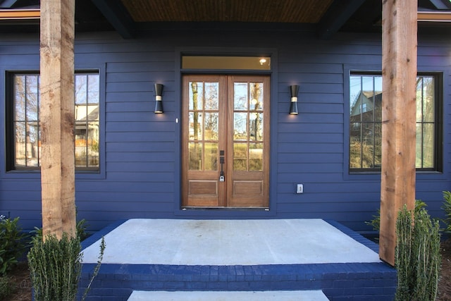 view of exterior entry featuring french doors and a patio