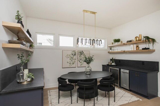 dining area with baseboards and light wood-style floors