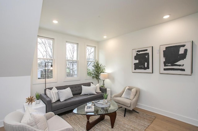 living area with recessed lighting, baseboards, and wood finished floors