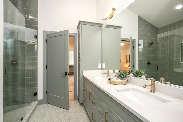 full bathroom featuring vaulted ceiling, double vanity, a sink, and a shower stall