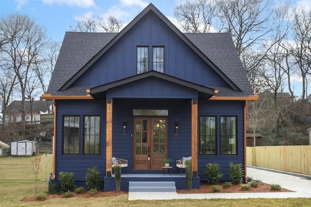 bungalow-style home featuring a porch, board and batten siding, and roof with shingles