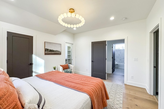 bedroom with light wood-type flooring, baseboards, and recessed lighting