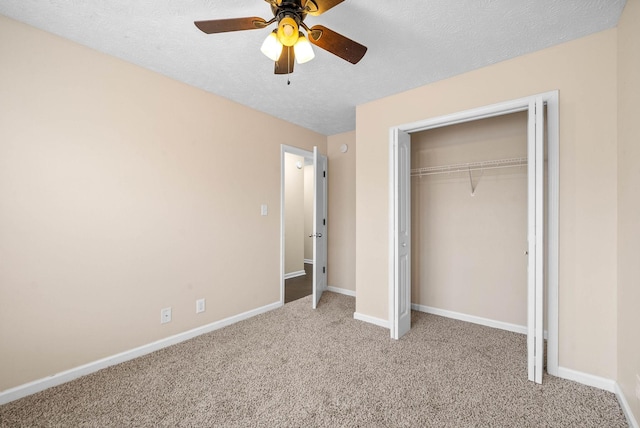 unfurnished bedroom featuring ceiling fan, light carpet, a textured ceiling, and a closet