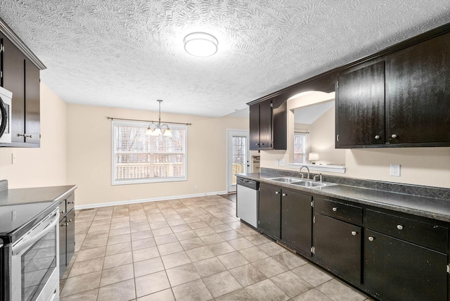 kitchen with dark brown cabinetry, sink, a healthy amount of sunlight, pendant lighting, and stainless steel appliances