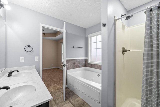 bathroom with vanity, tile patterned floors, shower with separate bathtub, and a textured ceiling