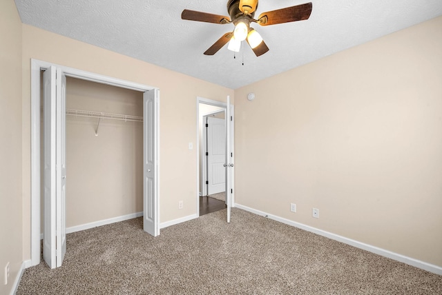 unfurnished bedroom featuring ceiling fan, carpet floors, a closet, and a textured ceiling