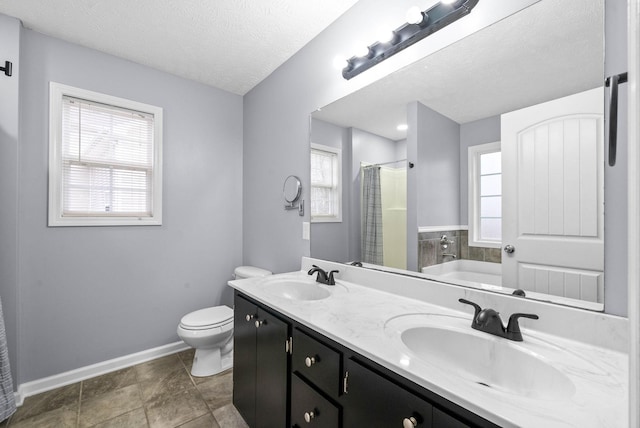 full bathroom featuring toilet, shower with separate bathtub, a textured ceiling, and a wealth of natural light