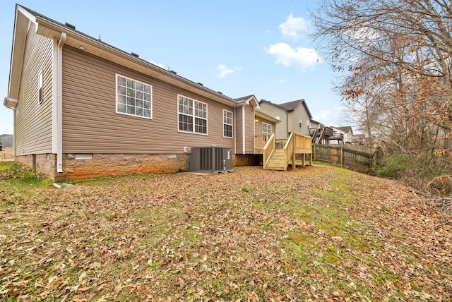 back of house with a wooden deck and central air condition unit